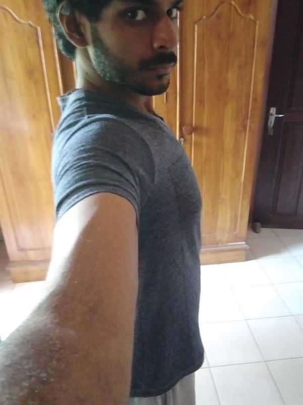 Haritha after, side view in the same grey t-shirt