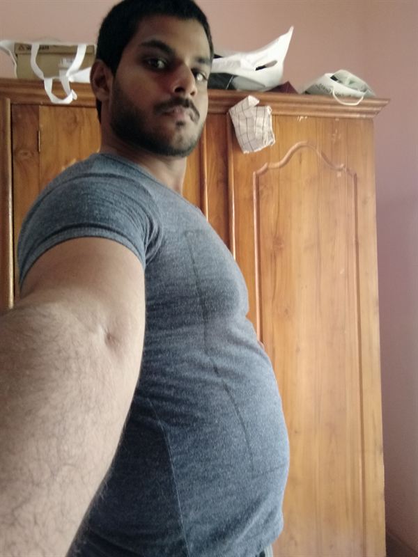 Haritha before, side view in a grey t-shirt
